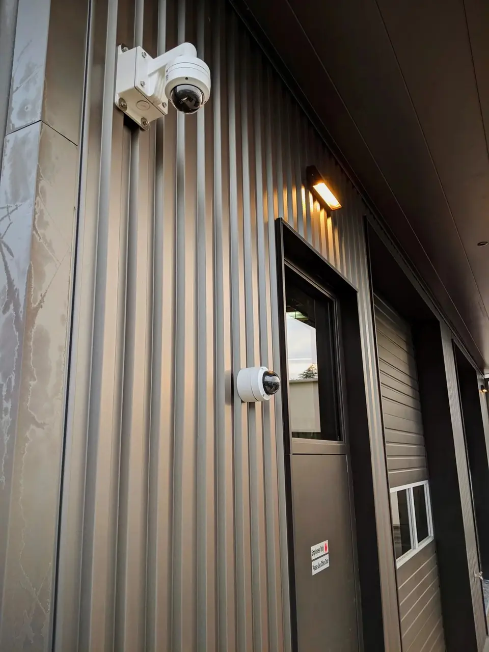 Security cameras above a commercial building entrance