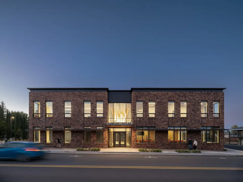 Two-story brick commercial building in Carlton, Oregon at dusk